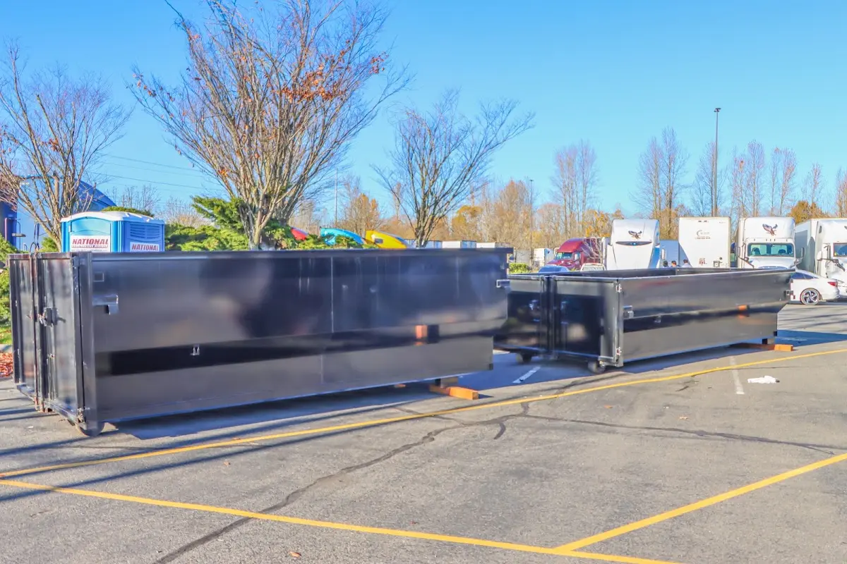 Professional dumpster rental service with roll-off container on residential driveway in Corsicana